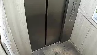 Man Holding Electric Bike Battery In Elevator