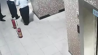 Man Holding Electric Bike Battery In Elevator