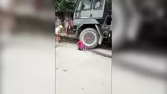 A Military Truck Drags A Woman Lying Under Its Wheels A(1)