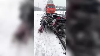 A Truck Pulls A Car That Was Hit By A Train And Is Filled With Dead Bodies