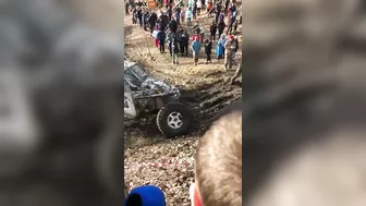 Guy Gets Too Close To A Mud Race And Gets Sandwiched Between Two Trucks