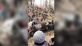 Guy Gets Too Close To A Mud Race And Gets Sandwiched Between Two Trucks