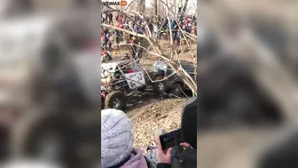 Guy Gets Too Close To A Mud Race And Gets Sandwiched Between Two Trucks