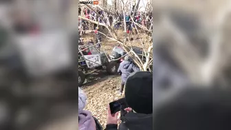 Guy Gets Too Close To A Mud Race And Gets Sandwiched Between Two Trucks