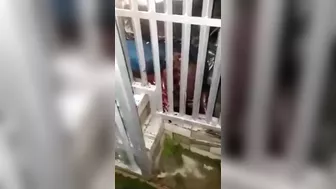 Man Trapped Between Car And Fence