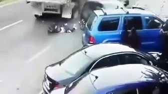 Man Trapped Between Reversing Car And Passing Truck