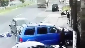 Man Trapped Between Reversing Car And Passing Truck