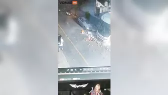 Woman Hit By Brick Wall After Bus Overturns - Video