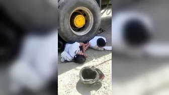 Couple On Motorcycle Falls Under Wheels Of Heavy Truck