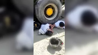Couple On Motorcycle Falls Under Wheels Of Heavy Truck