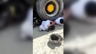 Couple On Motorcycle Falls Under Wheels Of Heavy Truck