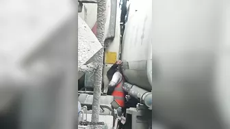 Man Trapped Between Trucks