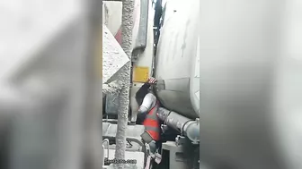 Man Trapped Between Trucks