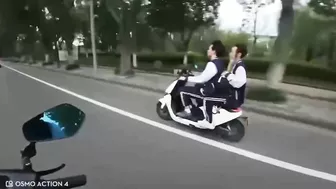 Motorcyclist Giving Middle Finger To Moped Driver