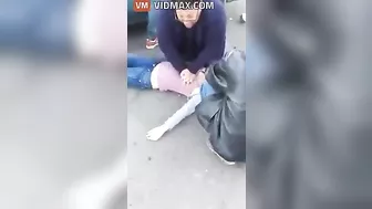 Nurse Performing CPR On Woman After Car Accident