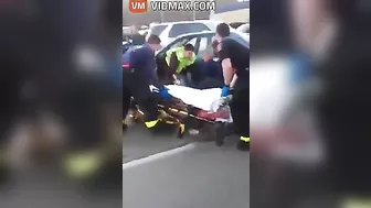 Nurse Performing CPR On Woman After Car Accident