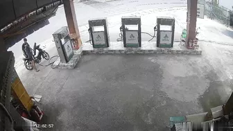 Motorcycle Speeding Into Gas Station