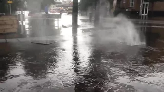 Terrifying moment a manhole cover explodes during flash floods