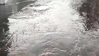 Terrifying moment a manhole cover explodes during flash floods