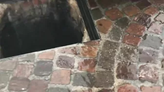 Terrifying moment a manhole cover explodes during flash floods