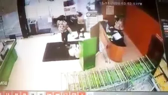 Husband Sitting In Car While Wife Putting Shopping Bags In Trunk