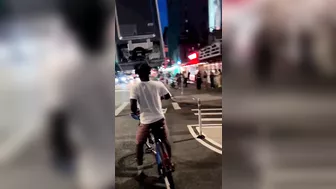 A Cyclist Carries A Refrigerator On His Head