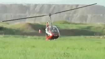 Small Helicopter Takes Off With Rotors Close To The Ground