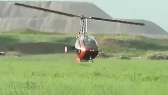 Small Helicopter Takes Off With Rotors Close To The Ground