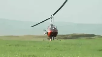 Small Helicopter Takes Off With Rotors Close To The Ground