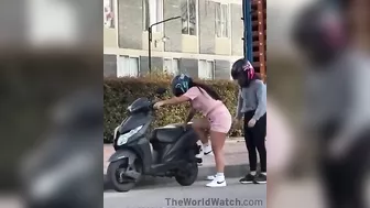 Women Trying To Figure Out How To Install A Kickstand On A Motorcycle