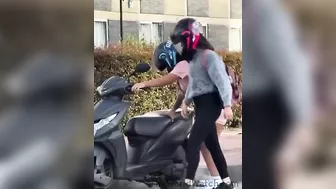 Women Trying To Figure Out How To Install A Kickstand On A Motorcycle