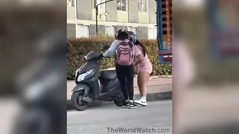 Women Trying To Figure Out How To Install A Kickstand On A Motorcycle
