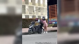 Women Trying To Figure Out How To Install A Kickstand On A Motorcycle