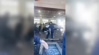 An Angry Customer Drives Past A CarMax Dealership