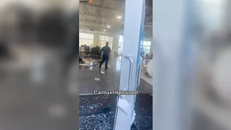 An Angry Customer Drives Past A CarMax Dealership