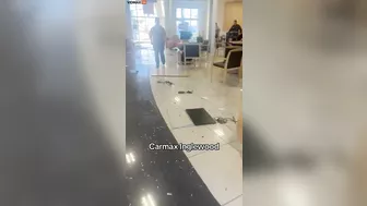 An Angry Customer Drives Past A CarMax Dealership
