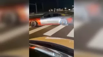 Leaning Out Of The Window While Performing Stunt Driving At An Intersection