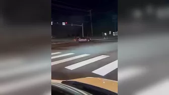 Leaning Out Of The Window While Performing Stunt Driving At An Intersection