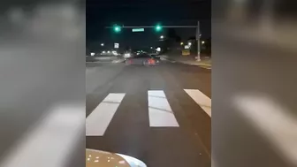 Leaning Out Of The Window While Performing Stunt Driving At An Intersection