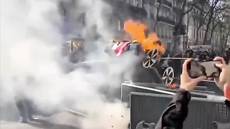 Protesters In Paris Display American Flags And Cardboard Teslas